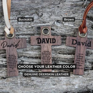 May include: Wooden cross pendants engraved with "David", available with buckskin or brown leather straps. The crosses feature Bible verses and are made of genuine deerskin leather.