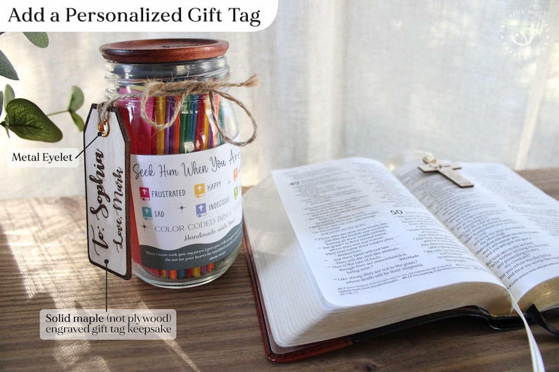 May include: A glass jar filled with colorful pencils, a wooden lid, and a personalized gift tag. The tag reads "To: Sophia Love, Mark." The jar is next to an open book with a wooden cross.