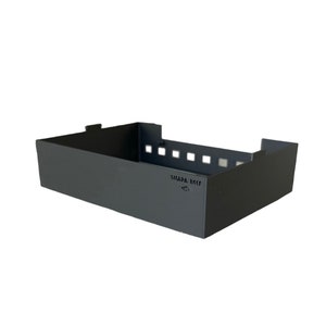 May include: A black metal storage basket with a rectangular shape and a label that reads "SIMADA RCCF".