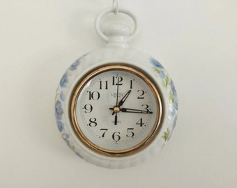 White and blue ceramic wall hanging clock. European vintage 1980s.