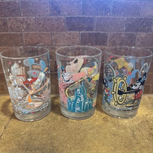 A set of 3 Walt Disney Glass and McDonald Glasses