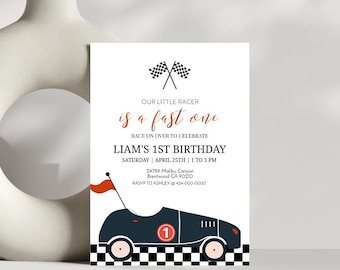 May include: A white invitation with a black and white checkered race track and a blue race car with a red flag. The text reads "Our little racer is a fast one. Race on over to celebrate Liam's 1st Birthday. Saturday, April 25th, 1 to 3 pm. 24789 Malibu Canyon, Brentwood CA 90210. RSVP to Ashley @ 424-000-0000."