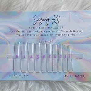 May include: A sizing kit for press-on nails. The kit includes clear plastic nail tips labeled 0-9, attached to a card with instructions. The card has a holographic, iridescent design and text that reads "Sizing Kit for Press-On Nails."