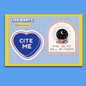 May include: Two stickers on a grid background. The left sticker is a blue heart with the text CITE ME in pink. The right sticker is an arch shape with a black crystal ball illustration and the text YOUR GRANT WILL BE FUNDED in black.