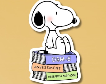 May include: A white cartoon dog with black ears and a black nose sits atop a stack of three books. The top book is purple and labeled DSM-5, the middle book is peach labeled ASSESSMENT, and the bottom book is green labeled RESEARCH METHODS.