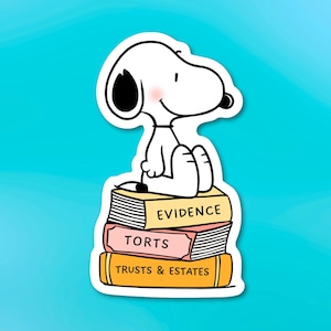 May include: A Snoopy sticker, in black and white, sitting atop a stack of law books. The books are labeled "EVIDENCE", "TORTS", and "TRUSTS & ESTATES" in bold, black text. The background is a solid, light blue.