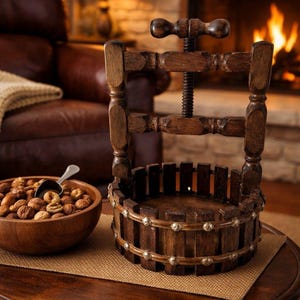 May include: A vintage wooden nutcracker with a screw mechanism, positioned on a round table. A wooden bowl filled with nuts and a small scoop sits nearby. The nutcracker has a dark brown finish and is surrounded by a warm, inviting ambiance.