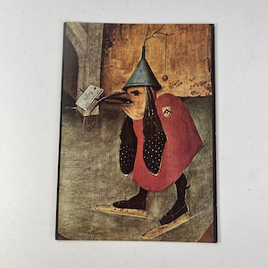 May include: A vintage postcard featuring a whimsical illustration of a bird-like figure in a red cloak and a pointed hat. The figure holds a tag that reads "fogo". The artwork has a rustic, aged appearance.
