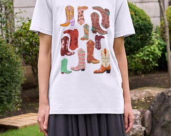 May include: White t-shirt with a colorful pattern of cowboy boots. The boots are all different colors and styles, and some have floral designs.