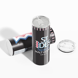 May include: Black insulated tumbler with a silver lid and the text "ST. DES PREMIUM MALT LIQUOR 8.2% alc/vol." A second tumbler lies on its side, displaying a red, white, and blue zigzag pattern.