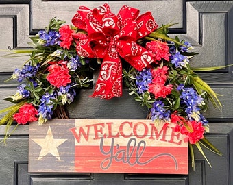 door wreath on grapevine made with Indian paintbrush and  realistic bluebonnets