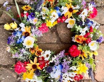 All season round grapevine wreath featuring multiple colors of Texas wildflowers including bluebonnets and Indian paintbrush perfect gift