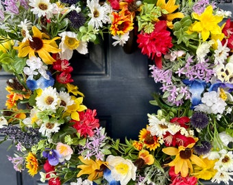 All the colors of the Texas wildflowers on a grapevine wreath perfect for your front porch or home decor including bluebonnet and paintbrush