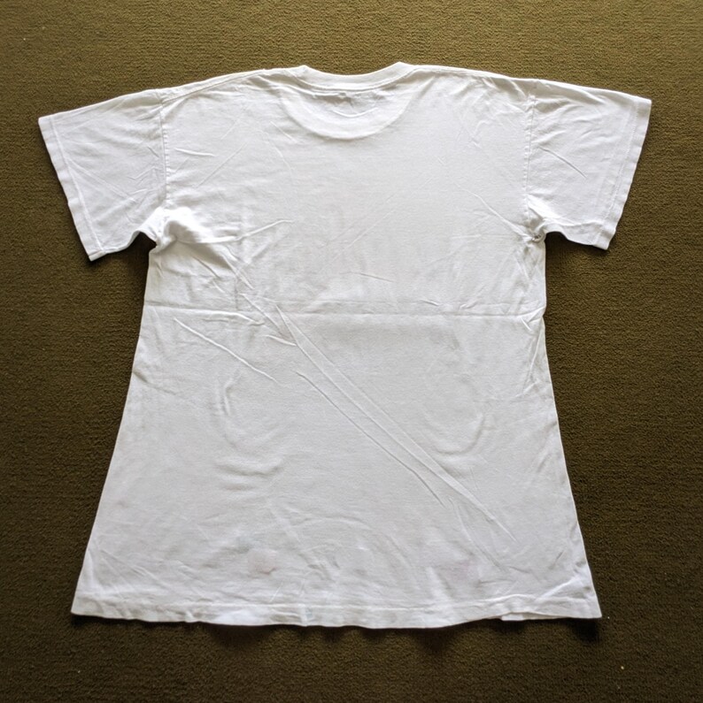 May include: A plain white t-shirt with short sleeves. The shirt is made of a soft, comfortable fabric.