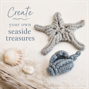 May include: A gray crocheted starfish and a blue crocheted seashell alongside a natural seashell, a small white stone, and a piece of driftwood. The text "Create your own seaside treasures" is printed in blue on the upper left side of the image.
