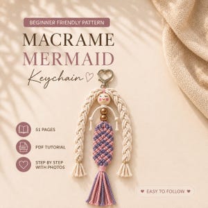 May include: A macrame mermaid keychain pattern featuring a 51-page PDF tutorial with step-by-step photos. The design includes a wooden bead face, braided off-white cord hair, and a purple and pink knotted tail with a heart-shaped metal clasp.