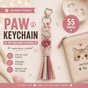 May include: A macrame keychain featuring a heart-shaped metal clasp and a knotted cord design in shades of pink, grey, and maroon, forming a paw print pattern with a fringed tassel end. The text reads PAW KEYCHAIN PDF MACRAME TUTORIAL.