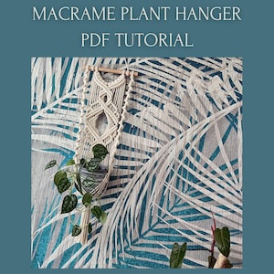 May include: Cream-colored macrame plant hanger with a wooden dowel, holding a potted plant with green leaves. The background features a teal and white palm leaf pattern. Text at the top reads "MACRAME PLANT HANGER PDF TUTORIAL".