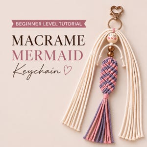 May include: A macrame mermaid keychain featuring a heart-shaped clasp, a wooden bead face with a painted expression, and a body crafted from knotted pink and purple cord. The text reads BEGINNER LEVEL TUTORIAL MACRAME MERMAID Keychain.