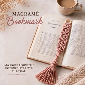 May include: A dusty rose macramé bookmark featuring a knotted pattern and a wooden ring at the top, resting on an open book titled Chapter Five The Unexpected Visitor. The bookmark ends in a long, thick tassel with loose, hanging cotton cords.