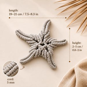 May include: A light gray, five-pointed star-shaped object made of knotted cord. Text indicates a length of 7.5-8.3 inches, a height of 0.8-2 inches, and a cord thickness of 5 mm. The texture is composed of tightly woven, repeating circular knots.