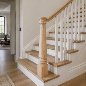 May include: A wooden staircase with light-colored wood steps and a white base. The handrail is also wood, with white balusters. The staircase is in a well-lit, neutral-toned interior space. The steps are approximately 10 inches high.