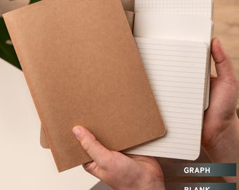 May include: A brown notebook with a kraft paper cover. The notebook has three different inserts: blank, lined, and graph paper.
