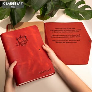 May include: Red leather journal with the text "And so the Adventure Begins" and the name "Hannah" embossed on the cover.