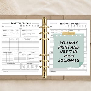 May include: A beige ring-bound planner open to a symptom tracker page with black text and lines. A light green sticky note is attached to the right page with the black text: YOU MAY PRINT AND USE IT IN YOUR JOURNALS. The planner has gold rings.