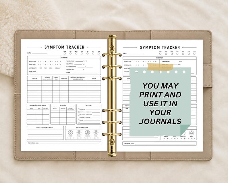 May include: A beige ring-bound planner open to a symptom tracker page with black text and lines. A light green sticky note is attached to the right page with the black text: YOU MAY PRINT AND USE IT IN YOUR JOURNALS. The planner has gold rings.