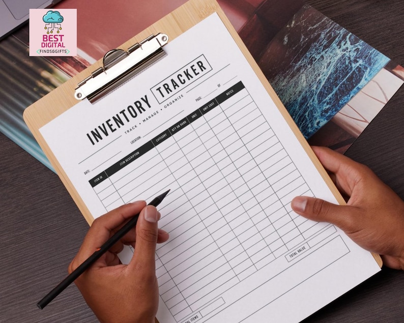 May include: A light-colored wooden clipboard holding a white inventory tracker sheet with black text. The form includes columns for date, item description, location, category, quantity on hand, unit, unit cost, and notes, with a total value box.