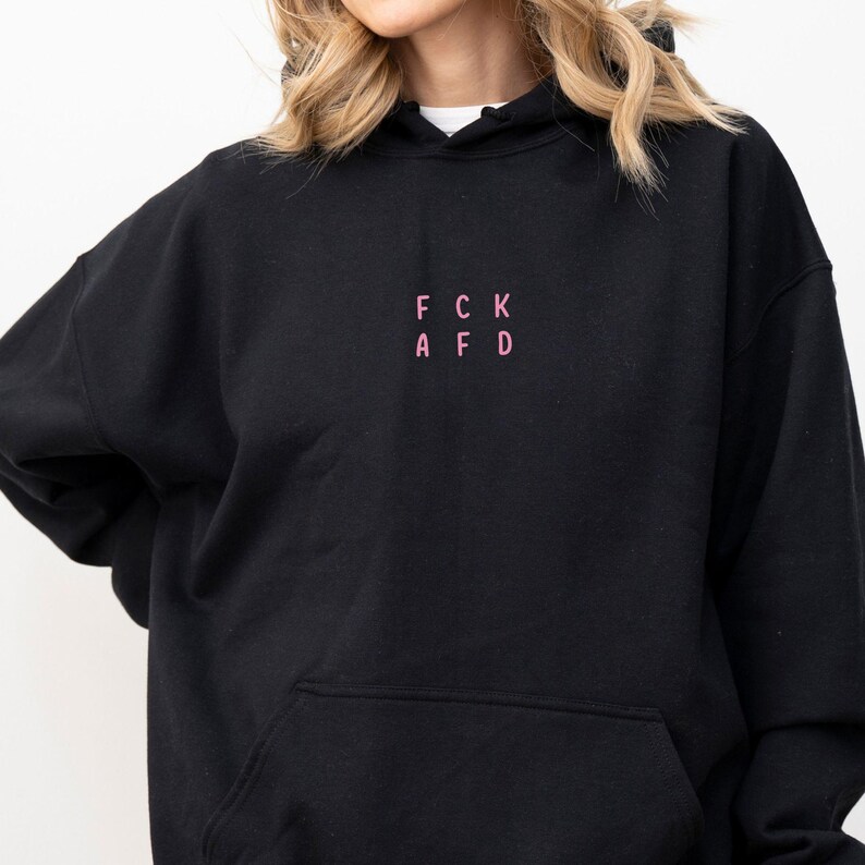 May include: Black hooded sweatshirt with a pink embroidered design that reads "FCK AFD".