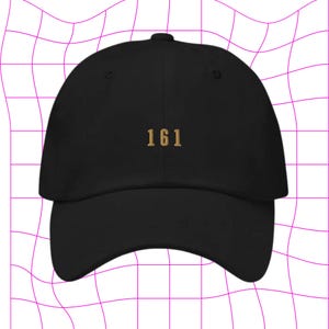 May include: A black baseball cap with a gold embroidered number "161" on the front.
