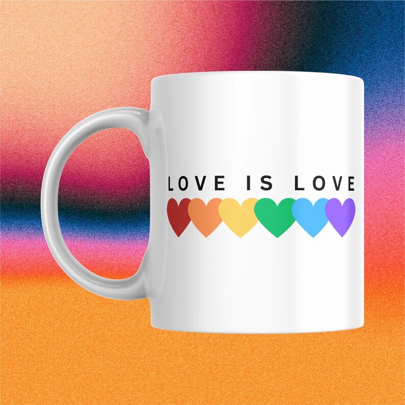 May include: White ceramic mug with the text "LOVE IS LOVE" and a row of six colorful hearts in rainbow colors. The mug has a curved handle and is set against a colorful gradient background.