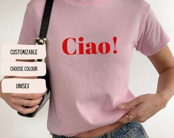 May include: Pink t-shirt with the word "Ciao!" printed in red.