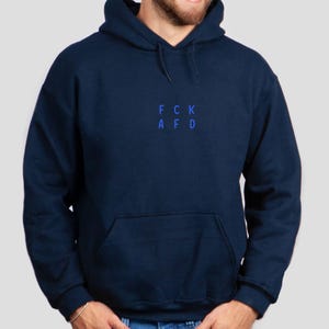 May include: A navy blue hooded sweatshirt with the text "FCK AFD" printed in blue on the front.