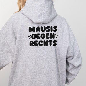 May include: Gray hooded sweatshirt with the text "MAUSIS GEGEN RECHTS" printed on the back.