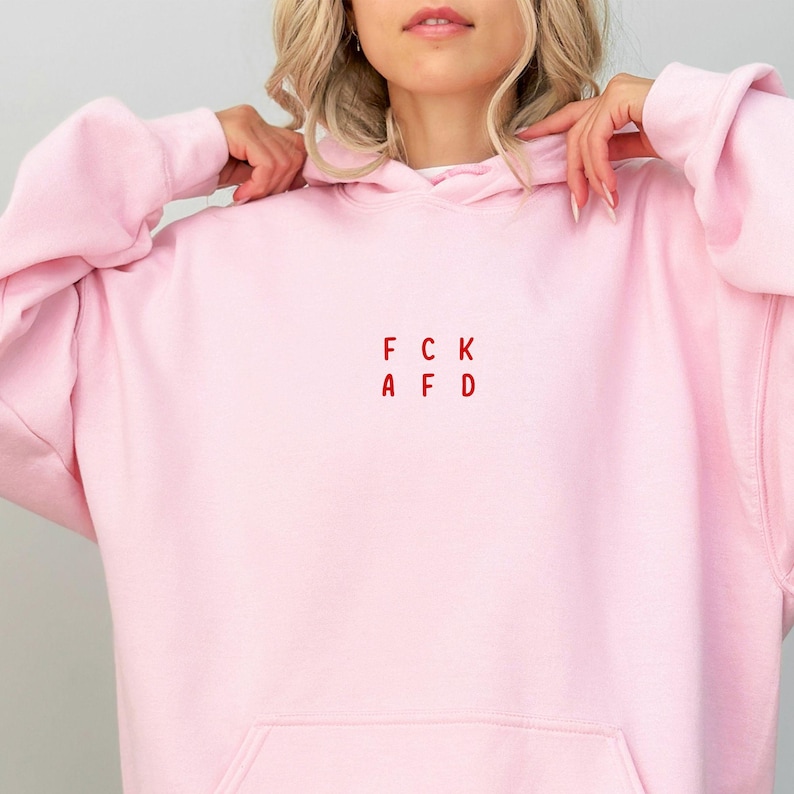 May include: A pink hoodie with the text "FCK AFD" in red letters.