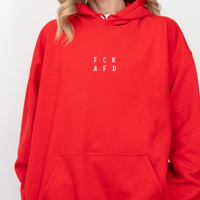 May include: Red hooded sweatshirt with a white graphic that says "FCK AFD".