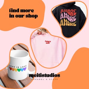 May include: An image featuring a white mug with "LOVE IS LOVE" and rainbow hearts, a pink hoodie with "future milf", and a black hoodie with "AMORE" in red, pink, and yellow. The text "find more in our shop" is also present.