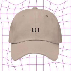 May include: A beige baseball cap with the number "161" embroidered on the front.