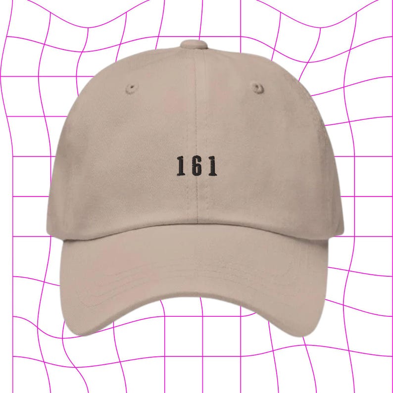 May include: A beige baseball cap with the number "161" embroidered on the front.