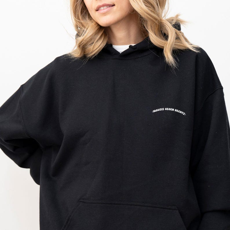 May include: Black hooded sweatshirt with the text "MAUSIS GEGEN RECHTS" in white lettering on the front.