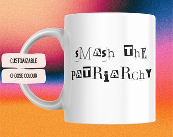 May include: White ceramic mug with the text "Smash the Patriarchy" printed in black letters. The letters are cut out and arranged in a staggered pattern.