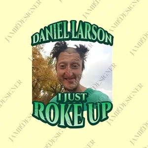 May include: A light yellow graphic tee featuring a photo of a man with the text "DANIEL LARSON" above the photo and "I JUST ROKE UP" below the photo in green text.
