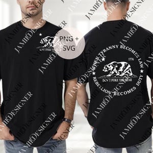 May include: Black t-shirt with a white graphic of a bear and the text "DON'T POKE THE BEAR". The back of the shirt features a circular design with a bear, stars, and the text "WHEN TYRANNY BECOMES LAW, REBELLION BECOMES DUTY" and "1776".