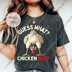 May include: Dark gray t-shirt featuring a cartoon chicken with its rear end facing forward. The text "GUESS WHAT? CHICKEN BUTT!" is printed above and below the chicken illustration in white and red.