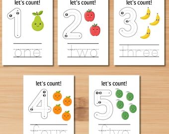 May include: Five printable flashcards with black outlines of the numbers 1 through 5. Each number has a dotted line for tracing and a corresponding number of cute cartoon fruits. The text "let's count!" appears at the top of each card. The words "one", "two", "three", "four", and "five" are written below each number.