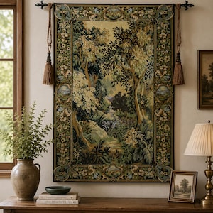 May include: A rectangular wall tapestry featuring a detailed forest landscape scene with lush trees and foliage, enclosed by a decorative floral border. The tapestry is suspended from a black metal rod with two hanging brown tassels on each side.