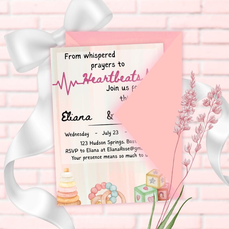 May include: A pink invitation with the text "From whispered prayers to Heartbeats!" and the names "Eliana &" is displayed. The invitation includes the date "July 23" and RSVP information. The invitation is decorated with watercolor illustrations of baby toys.